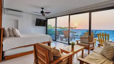 a bedroom with a bed and a view of the ocean at Camino Palmero Coveñas in Coveñas