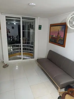 a living room with a couch and a window at Confortable y comodo apartamento in Cartagena de Indias