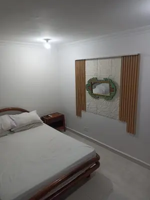 a bedroom with a bed and a mirror on the wall at Confortable y comodo apartamento in Cartagena de Indias