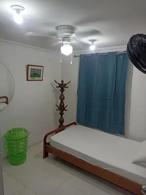 a bedroom with a bed with a blue curtain at Confortable y comodo apartamento in Cartagena de Indias