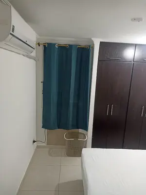 a bedroom with a blue shower curtain and a bed at Confortable y comodo apartamento in Cartagena de Indias