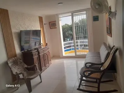 a living room with a couch and chairs and a tv at Confortable y comodo apartamento in Cartagena de Indias