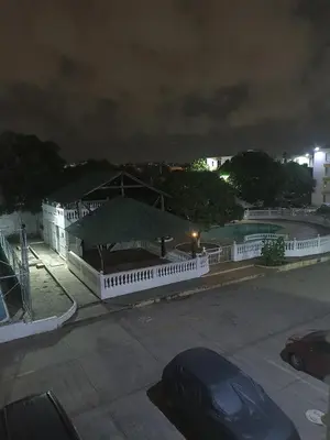 a building with a green umbrella in a parking lot at Confortable y comodo apartamento in Cartagena de Indias