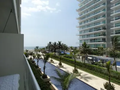 a view of a balcony with palm trees and a building at Morros Epic Cartagena in Cartagena de Indias