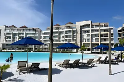 a resort with a swimming pool with chairs and umbrellas at 1ra Cristal Lagoons de Colombia in Cartagena de Indias
