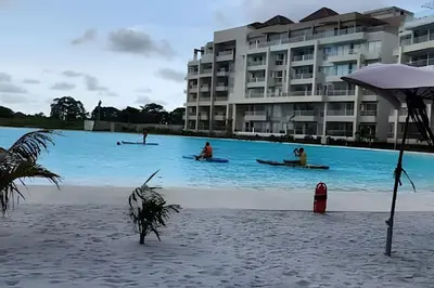 a group of people in kayaks in the water near a building at 1ra Cristal Lagoons de Colombia in Cartagena de Indias
