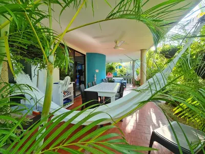 a conservatory with a hammock in the middle of plants at Lujosa cabana con piscina playa y servicio in San Silvestre
