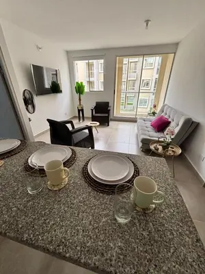a living room with a table with plates on it at Cartagena, Serena del Mar, Capriella in Manzanillo del Mar