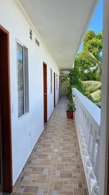 a hallway of a house with white walls and a staircase at Asís apartamentos in Tolú