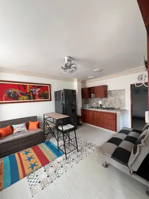 a living room with a couch and a table at Asís apartamentos in Tolú