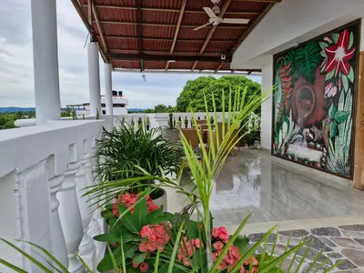 an outdoor patio with a mural on the wall at Asís apartamentos in Tolú