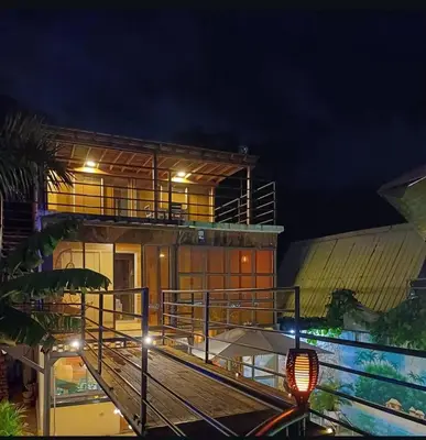 a house with a balcony and a building at night at Alta vista Turbaco in Cartagena de Indias