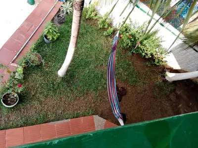 an overhead view of a garden with a umbrella at Habitación con aire y piscina in Santa Veronica