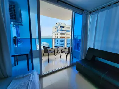 a living room with a couch and a table and chairs at Apartamento Confort 13 Vista Caribe in Cartagena de Indias