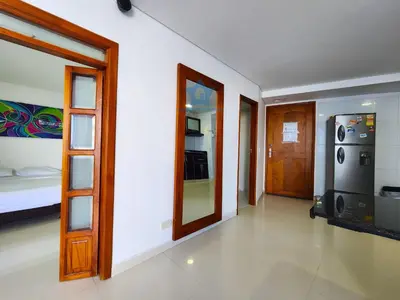 an empty room with a bed and a door at Apartamento Confort 13 Vista Caribe in Cartagena de Indias
