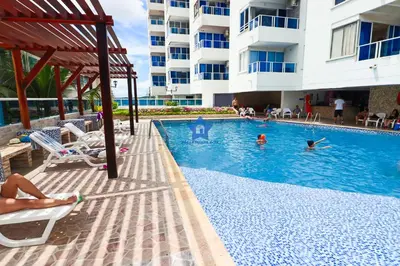 a swimming pool at a hotel with people swimming in it at Estudio Sky View - Piso 20 in Cartagena de Indias