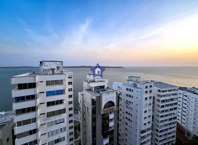 a building with a cross on top of it next to the water at Estudio Vista Mágica - Piso 17 in Cartagena de Indias