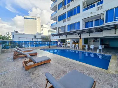 a swimming pool with lounge chairs and a building at Estudio Vista Mágica - Piso 17 in Cartagena de Indias