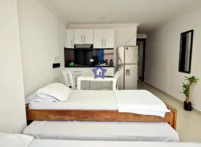 a small room with two beds and a refrigerator at Estudio Vista Mágica - Piso 17 in Cartagena de Indias