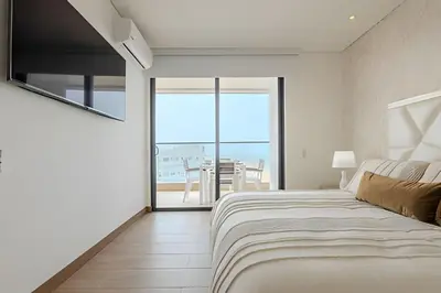 a bedroom with a bed and a view of the ocean at Vista al Mar/ Centro Histórico/ Nuevo Piso 26 1BR in Cartagena de Indias