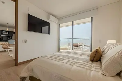 a bedroom with a large bed and a large window at Vista al Mar/ Centro Histórico/ Nuevo Piso 26 1BR in Cartagena de Indias
