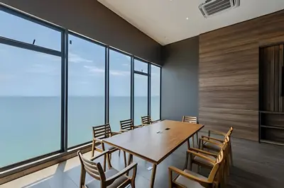 a dining room with a table and chairs and windows at Vista al Mar/ Centro Histórico/ Nuevo Piso 26 1BR in Cartagena de Indias