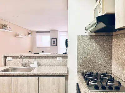 a kitchen with a stove top oven next to a sink at Escapada 2BR en Ocean Drive in Cartagena de Indias