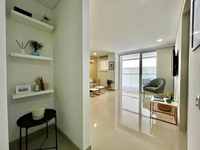 a room with a hallway with a chair and a table at Escapada 2BR en Ocean Drive in Cartagena de Indias