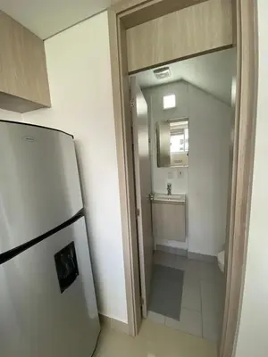 a kitchen with a refrigerator and a small bathroom at Gran y cómodo Loft en Cartagena in Cartagena de Indias