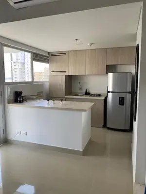 a kitchen with a white counter and a refrigerator at Gran y cómodo Loft en Cartagena in Cartagena de Indias