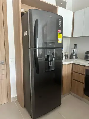 a large black refrigerator in a kitchen at baia kristal paraiso aguas cristalinas in Cartagena de Indias