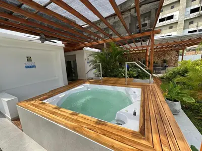 a jacuzzi tub on the patio of a building at baia kristal paraiso aguas cristalinas in Cartagena de Indias