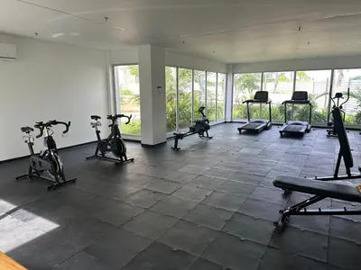 a gym with exercise bikes in a room with windows at baia kristal paraiso aguas cristalinas in Cartagena de Indias