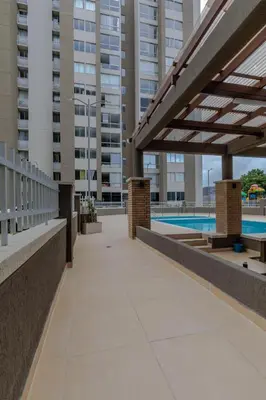 a walkway in a building with a swimming pool at Lux University Apt in Barranquilla