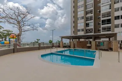 a swimming pool in the middle of a building at Lux University Apt in Barranquilla