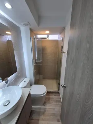a bathroom with a toilet and a sink and a shower at Lux University Apt in Barranquilla