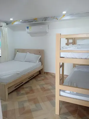 a room with two bunk beds and a ladder at CABAÑAS CALIPSO, 2 piso in Coveñas