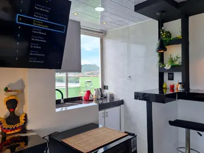 a kitchen with black counter tops and a window at Studio Apartment Old City Cartagena Almirante in Cartagena de Indias