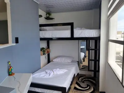 two bunk beds in a room with a window at Studio Apartment Old City Cartagena Almirante in Cartagena de Indias