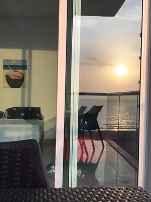 a room with a view of the ocean from a window at Morros Vitri Disfruta de acceso directo a la playa in Cartagena de Indias