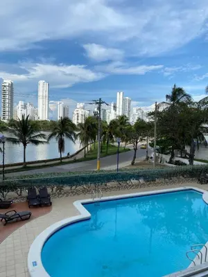 a large swimming pool with a city in the background at Toscana Suite 3009 in Las Margaritas