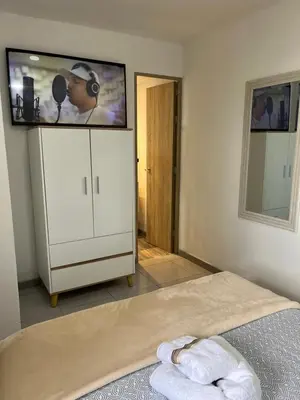 a bedroom with a flat screen tv on a wall at Sunset47 in Cartagena de Indias