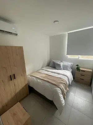 a small bedroom with a bed and a window at Sunset47 in Cartagena de Indias