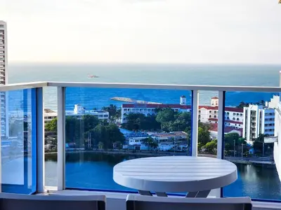 a balcony with a table and a view of the ocean at Apartamento Piso 18 Blue Horizon in Cartagena de Indias