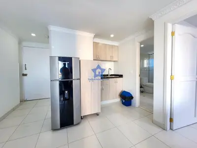 a kitchen with a refrigerator in the middle of a room at Apartamento Piso 18 Blue Horizon in Cartagena de Indias