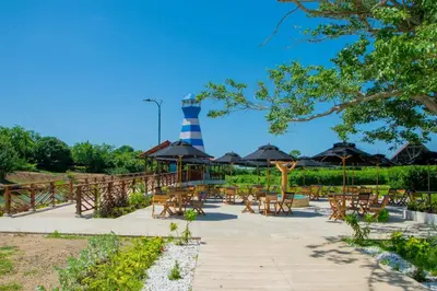 a lighthouse in a park with chairs and a lighthouse at Parque Caribe Aventura in El Cerrito