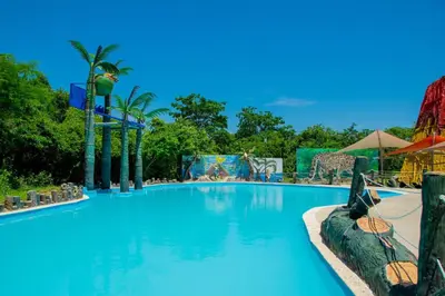 a pool at a resort with blue water at Parque Caribe Aventura in El Cerrito