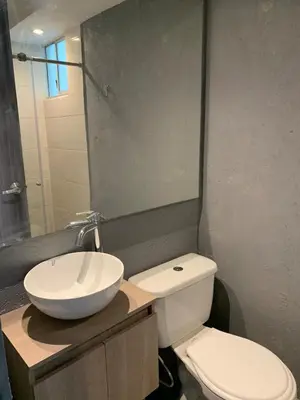 a bathroom with a sink and a toilet and a mirror at Apartamento acogedor in Barranquilla