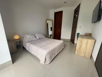 a bedroom with a bed and a television in it at Excelente apartaestudio in Sincelejo