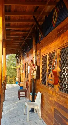 a room with a wall with guitars on it at Cabaña Alojamiento Valhalla in Rincón